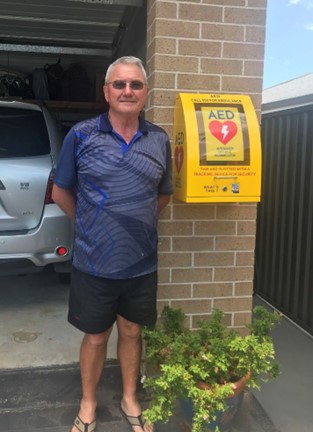 Graham Miles pictured with his Heart of the Nation AED unit installed on the exterior of his house.